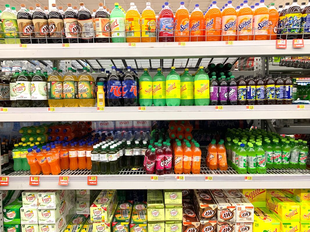 soda bottles on a shelf in grocery store