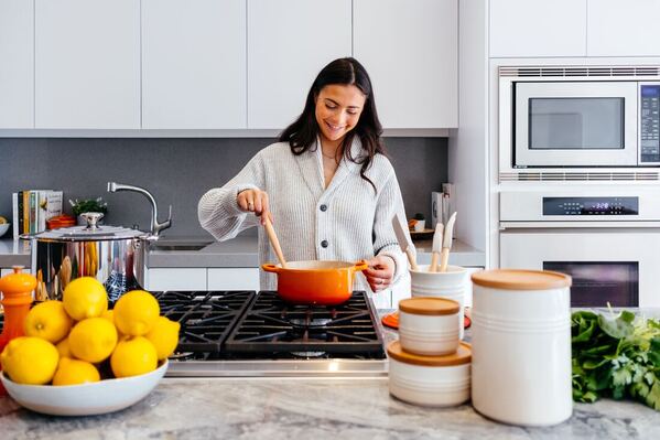 woman mindfully stiring pot in kitchen